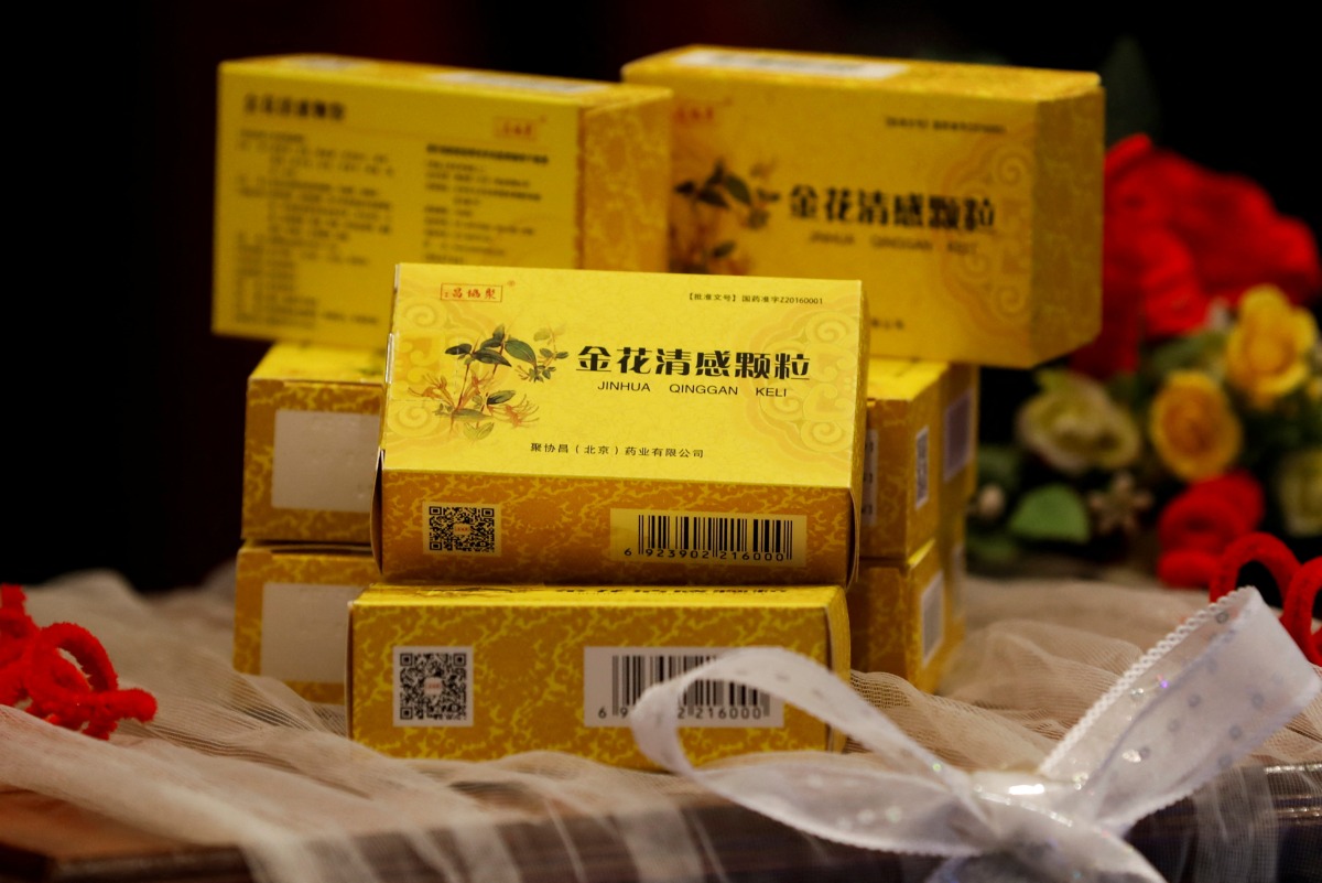 Packs of Chinese traditional herbal medicine Jinhua Qinggan Granules (JHQG) for the treatment of coronavirus (COVID-19) disease are displayed during a ceremony after completion of clinical trial on the efficacy and safety, at the International Centre for Chemical and Biological Sciences of Karachi University in Karachi, Pakistan January 17, 2022. REUTERS/Akhtar Soomro
