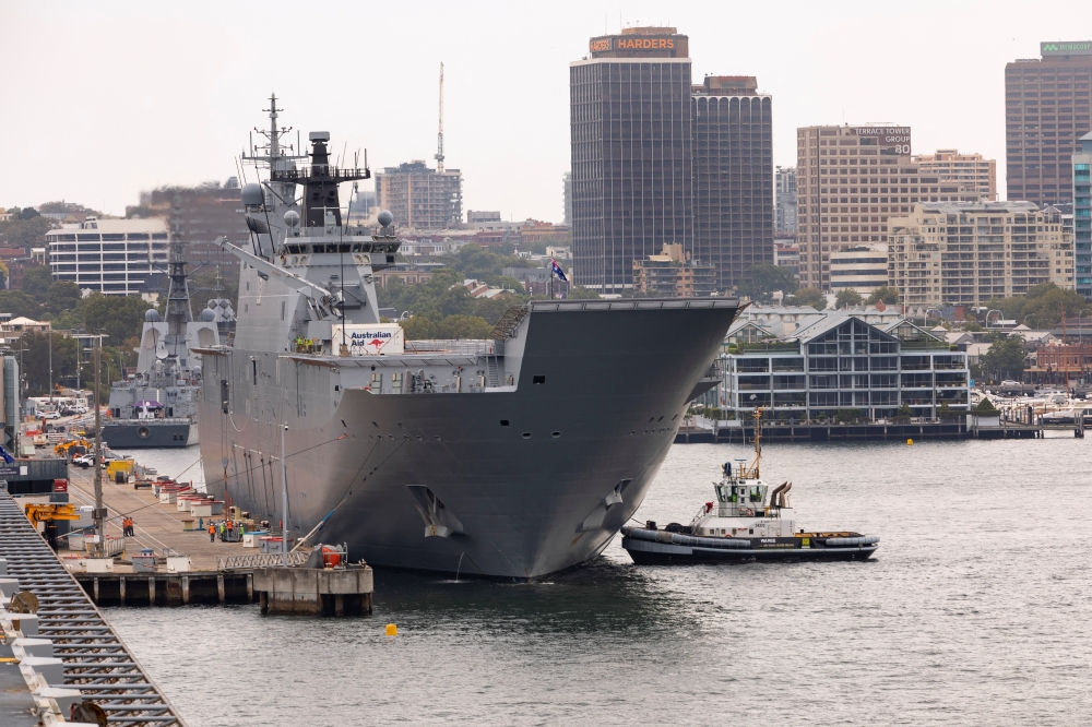 HMAS Adelaide departs Fleet Base East at Garden Island, Sydney, Australia, for Brisbane in preparation to provide disaster relief and assistance to Tonga, January 17, 2022. Australian Department of Defence/Handout via Reuters