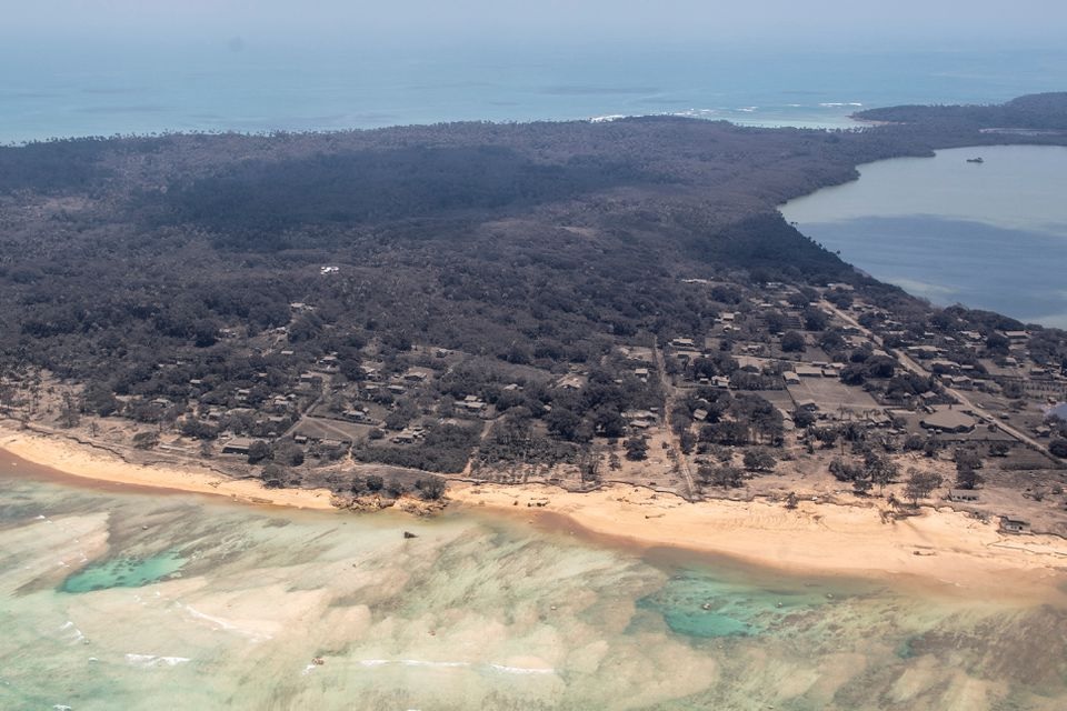 A general view from a New Zealand Defence Force P-3K2 Orion surveillance flight shows heavy ash fall over Nomuka in Tonga after the Pacific island nation was hit by a tsunami triggered by an undersea volcanic eruption January 17, 2022. New Zealand Defence Force/Handout via REUTERS

