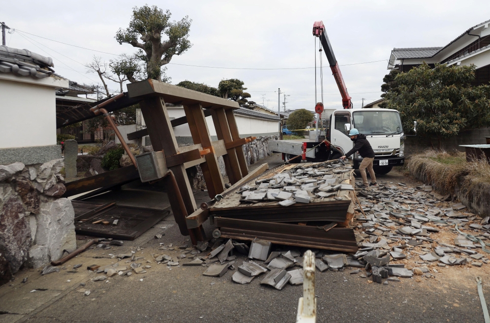 A collapsed gate to the residential house caused by an earthquake is seen in Oita, southern Japan January 22, 2022, in this photo taken by Kyodo. Kyodo/via Reuters