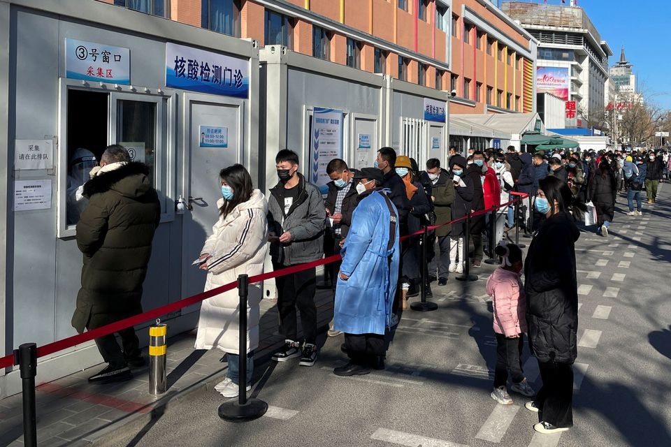 People line up to take nucleic acid tests at a testing site outside a hospital following the coronavirus disease (COVID-19) outbreak in Beijing, China January 17, 2022. REUTERS/Carlos Garcia Rawlins

