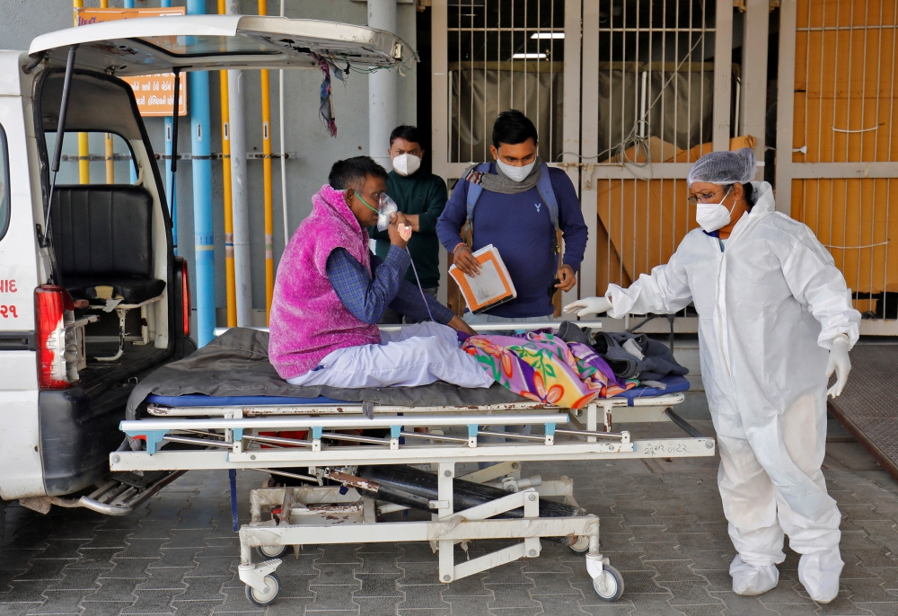 A man with breathing problem is wheeled inside a COVID-19 hospital for treatment during the ongoing coronavirus disease (COVID-19) in Ahmedabad, India, January 24, 2022. REUTERS/Amit Dave