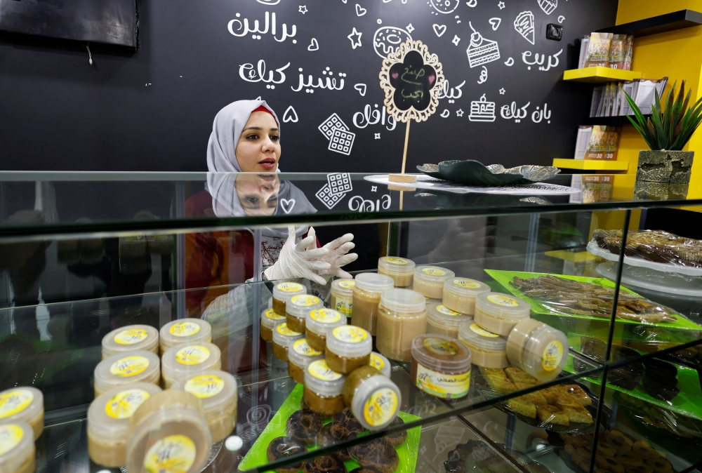 Hana Al-Wakeel, prepares sweets at her 