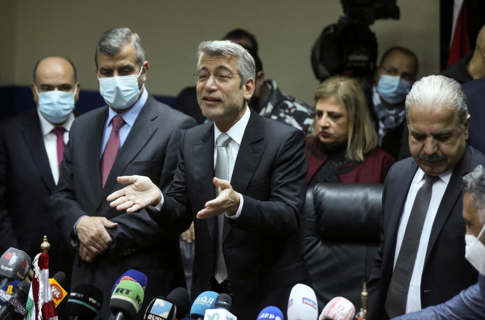 Lebanon's Energy Minister Walid Fayad gestures as he stands next to Syria's Electricity Minister Ghassan al-Zamil and Jordan's Minister of Energy and Mineral Resources Saleh Ali Hamed Al-Kharabsheh after signing a deal that will supply Lebanon with electricity, at Ministry of Energy and Water in Beirut, Lebanon January 26, 2022. REUTERS/Mohamed Azakir
