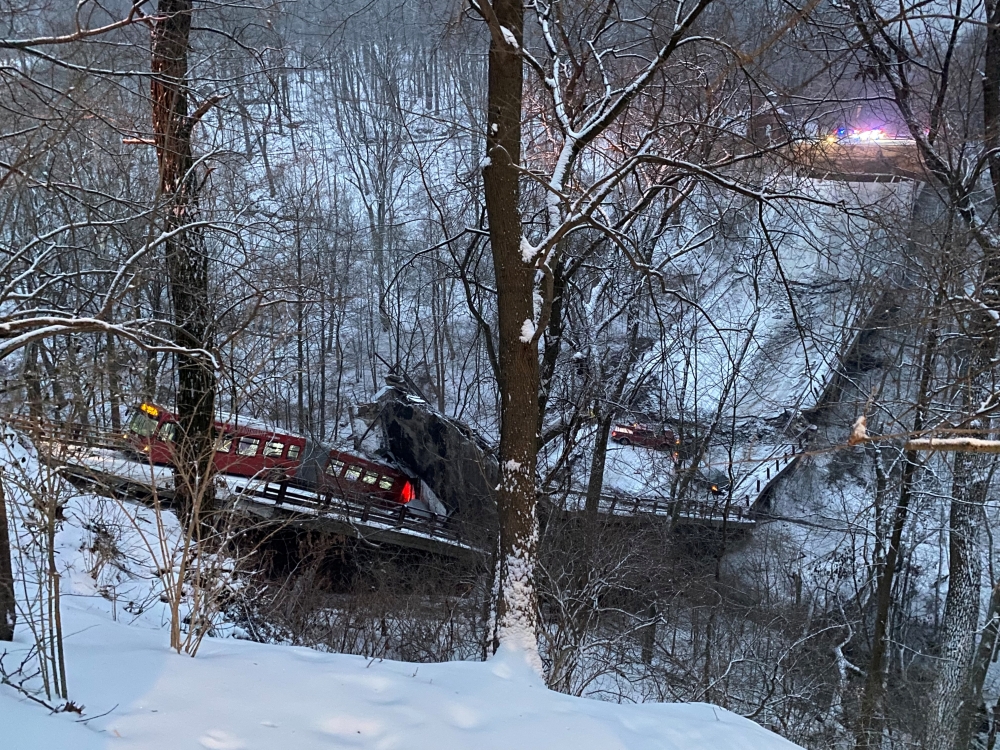 Vehicles sit on a collapsed bridge in Pittsburgh, Pennsylvania, U.S. January 28, 2022, in this image obtained from social media. Greg Barnhisel via REUTERS