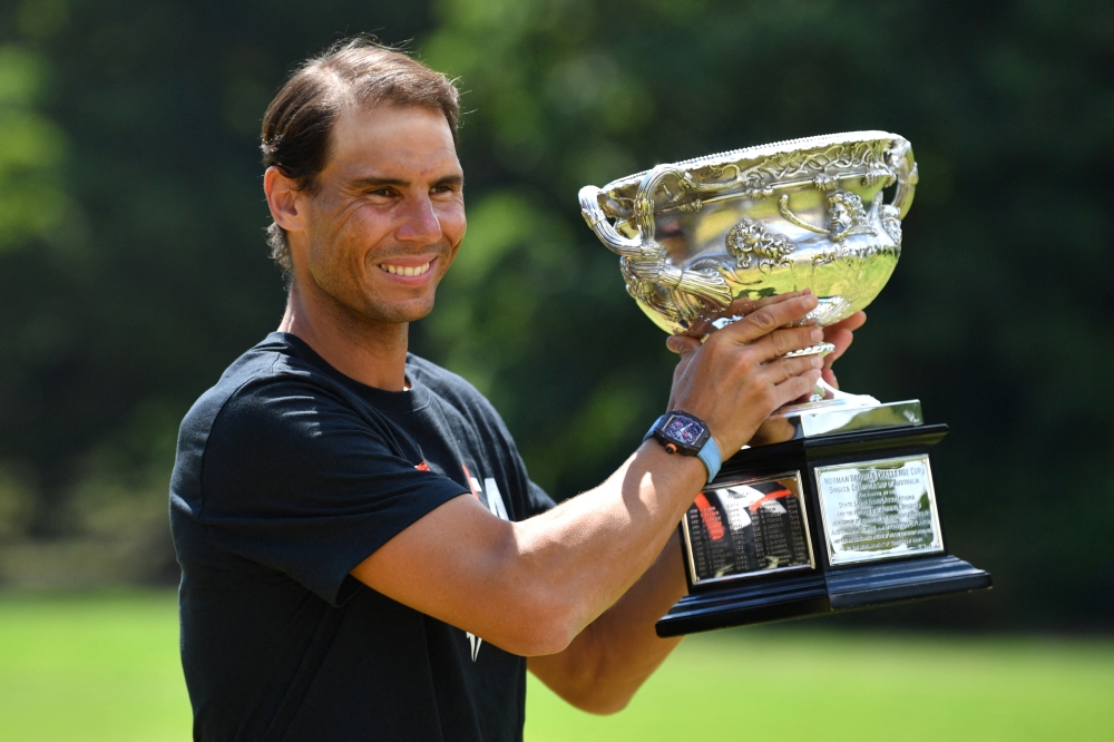 January 31, 2022 Spain's Rafael Nadal poses with the Norman Brookes Challenge Cup trophy after winning the Australian Open Joel Carrett/AAP Image via REUTERS