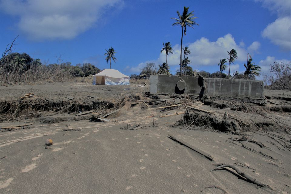 A general view shows damaged buildings and landscape covered with ash following the volcanic eruption and tsunami in Kanokupolu, Tonga, January 23, 2022. Tonga Red Cross Society/Handout via Reuters
