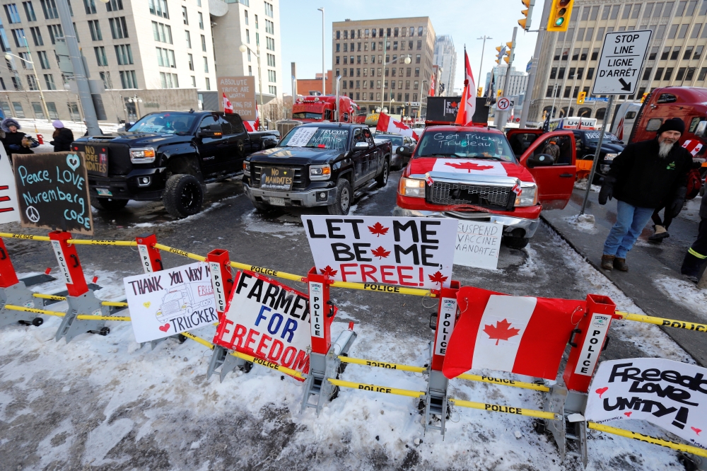 Signs sit on a police baracade as truckers and their supporters continue to protest coronavirus disease (COVID-19) vaccine mandates, in Ottawa, Ontario, Canada, February 7, 2022. REUTERS/Patrick Doyle
