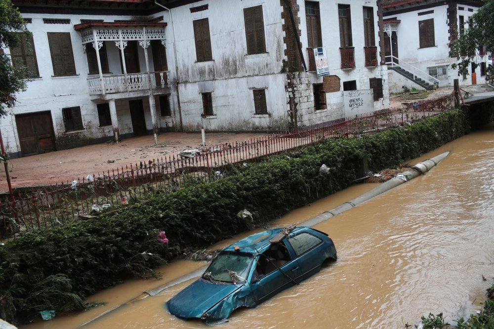 A car is pictured at a river after pouring rains in Petropolis, Brazil, February 16, 2022. REUTERS/Ricardo Moraes