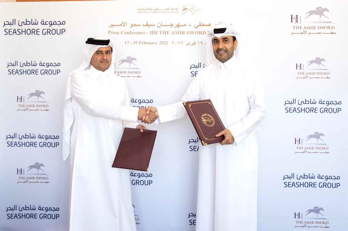 Qatar Racing and Equestrian Club Chairman Issa bin Mohammed Al Mohannadi and Seashore Group CEO Salem Saeed Al Mohannadi shake hands during the sponsorship signing ceremony.