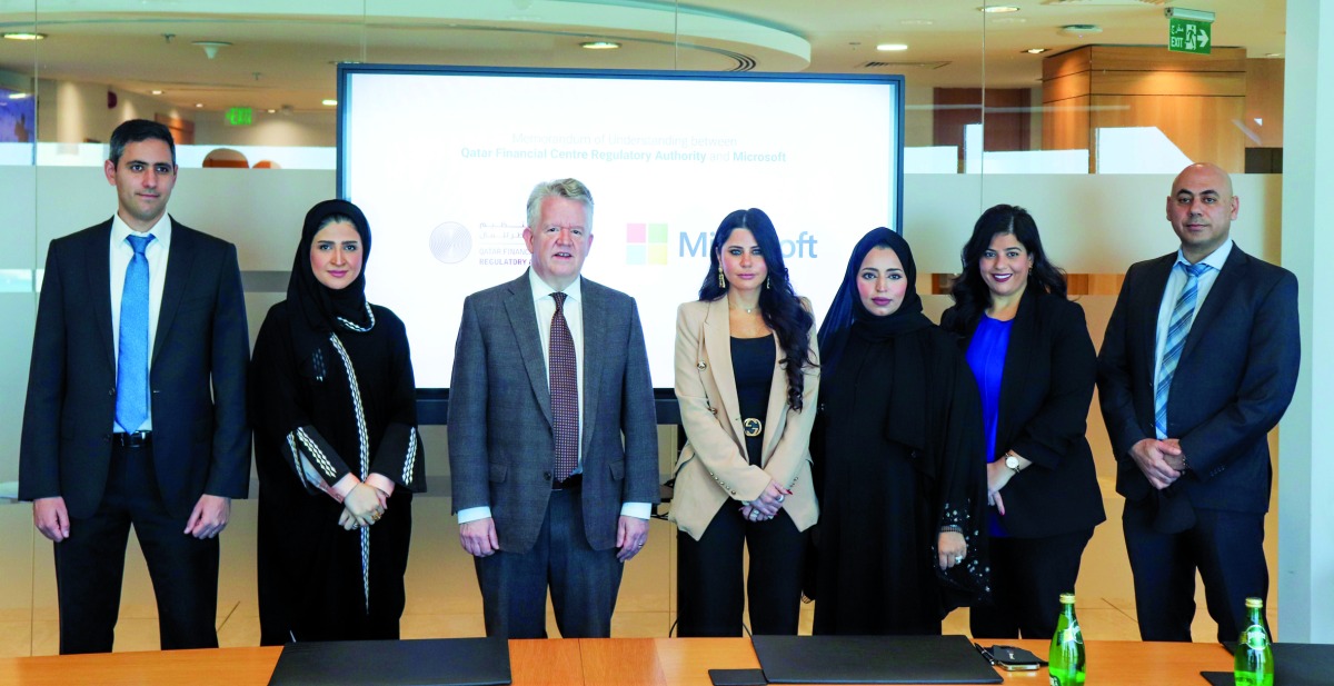 Fatma Abdulrahman Al Meer (second left), Chief Financial Officer and Chief Operating Officer at QFCRA, Lana Khalaf (centre), Country Manager at Microsoft Qatar, and other officials, during the agreement signing ceremony. 