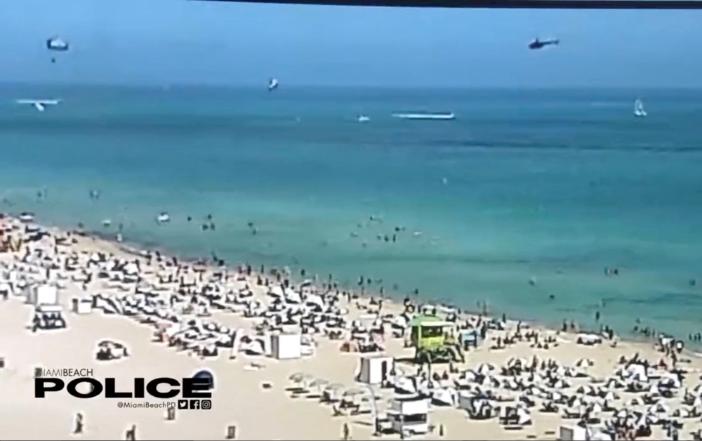 A view of a helicopter before crashing into the ocean in Miami Beach, Miami, Florida, U.S., February 19, 2022, in this still image obtained from social media video. Courtesy of Miami Beach Police Department/@MiamiBeachPD/via REUTERS