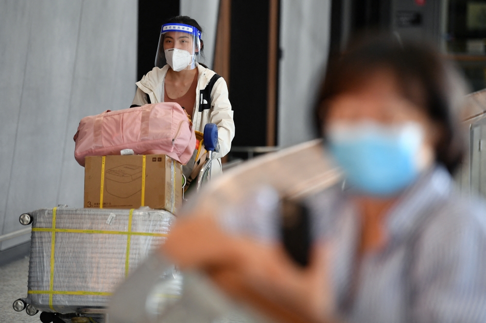 International passengers arrive at Melbourne Airport, after Australia reopened its international borders to travelers vaccinated against the coronavirus disease (COVID-19), in Melbourne, Australia February 21, 2022. AAP Image/Joel Carrett via REUTERS