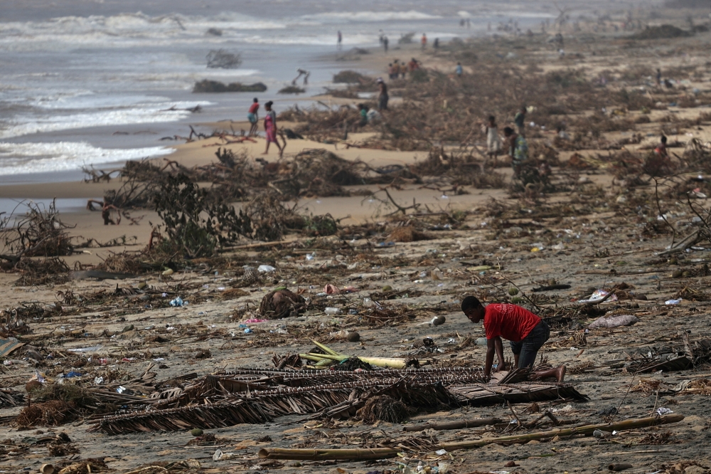 A boy searches among debris on the beach, in the aftermath of Cyclone Batsirai, in the town of Mananjary, Madagascar, February 8, 2022. REUTERS/Alkis Konstantinidis TPX IMAGES OF THE DAY/File Phot