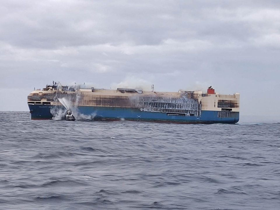 The ship, Felicity Ace, which was traveling from Emden, Germany, where Volkswagen has a factory, to Davisville, in the U.S. state of Rhode Island, burns more than 100 km from the Azores islands, Portugal, February 18, 2022. Portuguese Navy (Marinha Portuguesa)/Handout via REUTERS

