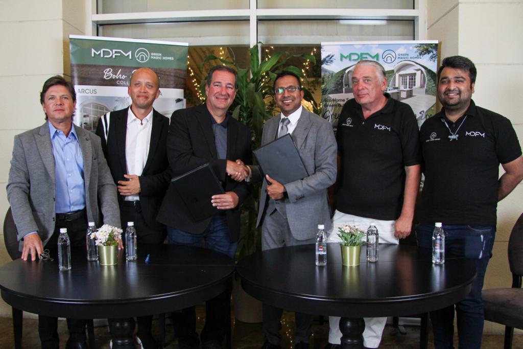 MDFM Managing Director & Co-Founder Kushal Kumar and Green Magic Homes CEO Gustavo Santander exchanging documents after singing the agreement.