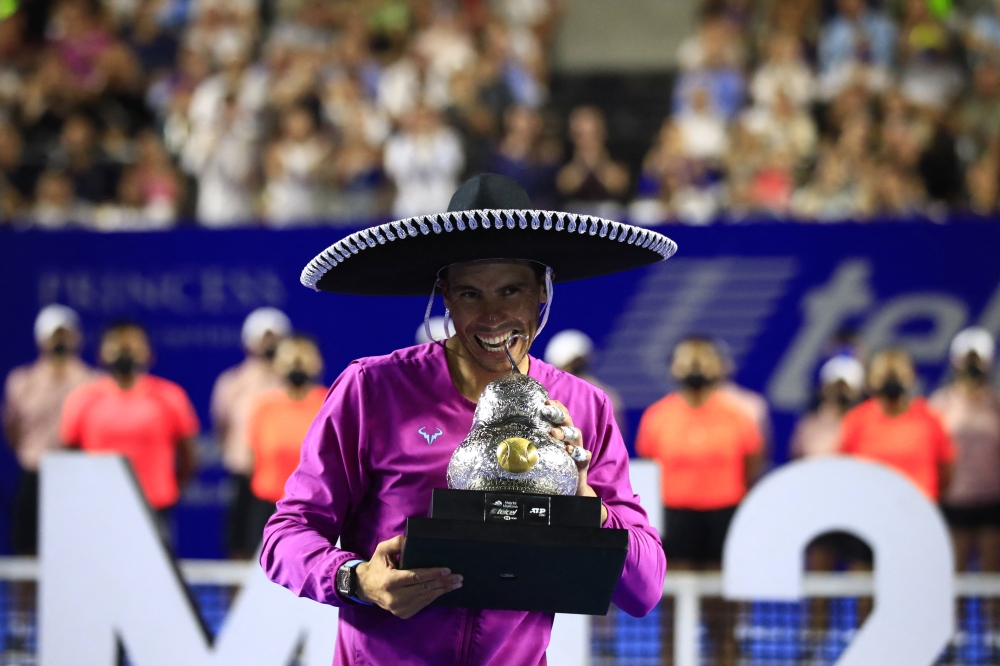 February 26, 2022 Spain's Rafael Nadal celebrates with the trophy after winning the final REUTERS/Henry Romero