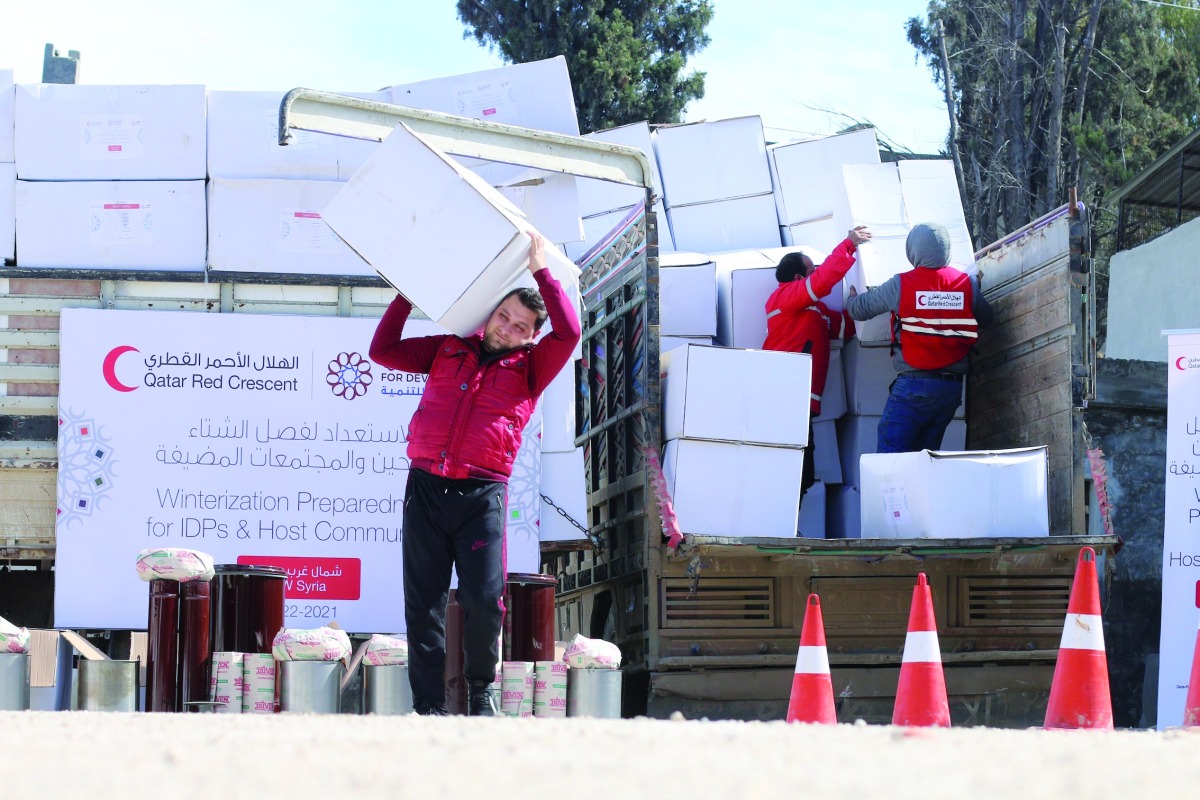 QRCS representatives delivering winterisation aid to IDPs in Syria.