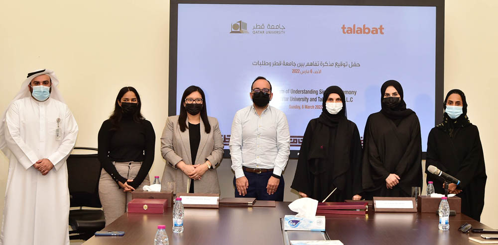 Officials from the QU and talabat at the MoU signing event.