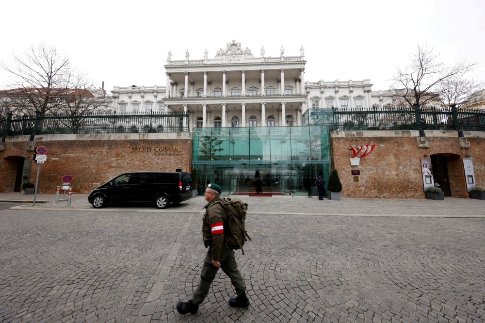 FILE PHOTO: A member of Austrian armed forces walks past Palais Coburg, the site of a meeting of the Joint Comprehensive Plan of Action (JCPOA), in Vienna, Austria, February 8, 2022. REUTERS/Leonhard Foeger