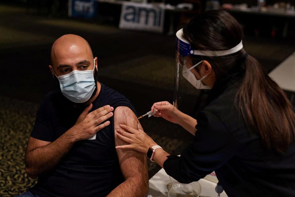 Nurse immuniser Kelie Lee administers the AstraZeneca vaccine to a patient at a coronavirus disease (COVID-19) vaccination clinic at the Bankstown Sports Club during a lockdown to curb an outbreak of cases in Sydney, Australia, August 25, 2021. REUTERS/Loren Elliott

