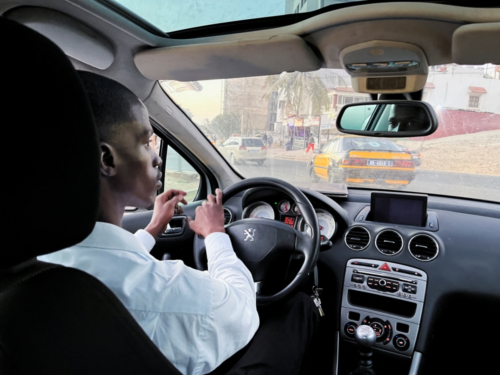 Abdourahmane, a user of the French ride-hailing app Heetch, is seen in his taxi in Dakar, Senegal, February 28, 2022. Picture taken February 28, 2022. REUTERS/Elodie Toto