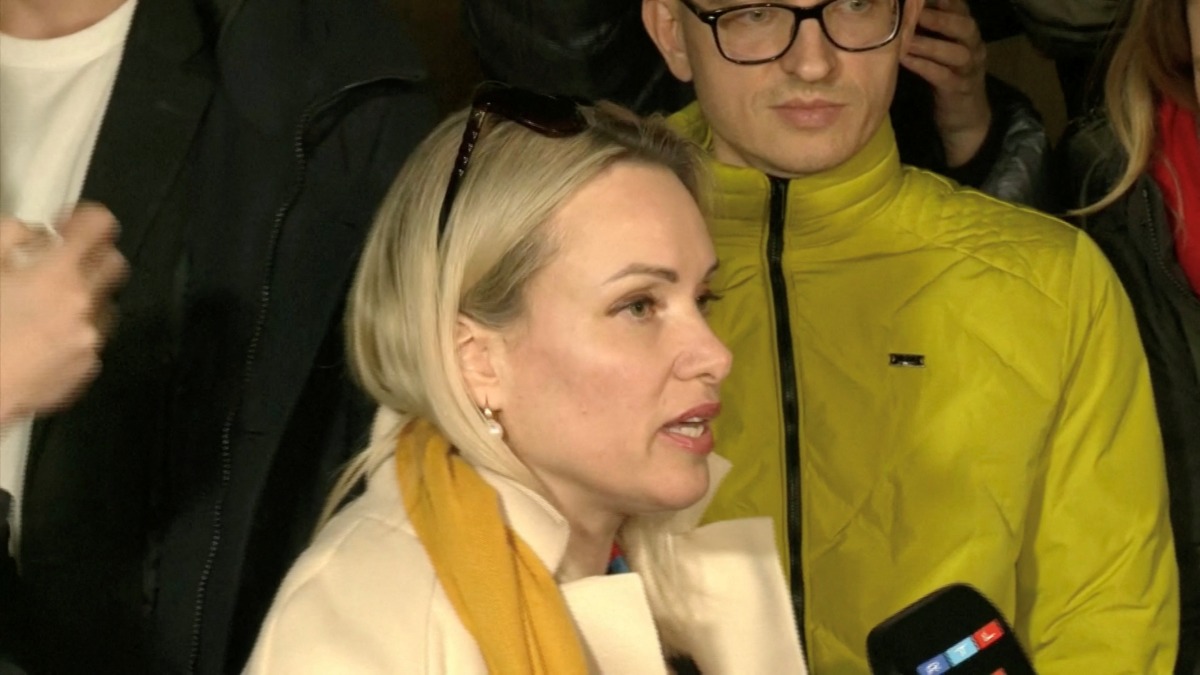 Marina Ovsyannikova, a Channel One employee who staged an on-air protest as she held up a anti-war sign behind a studio presenter, speaks to the media as the leaves the court building in Moscow, Russia March 15, 2022 in this still image taken from a video. REUTERS TV via REUTERS
