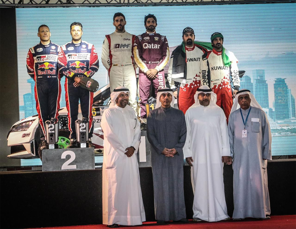 Qatar's Khaled Al Suwaidi and Hugo Magalhaes with other podium winners and officials at the end of the Kuwait International Rally, yesterday. 