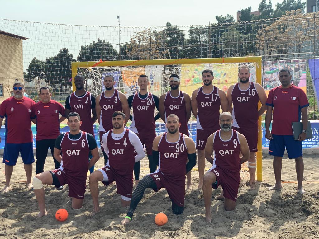 Qatar national beach handball team players and officials pose for a photograph on the eve of their opening match against the Philippines in Tehran. 