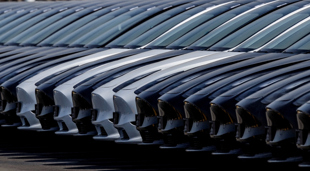 Tesla cars are seen parked at the construction site of the new Tesla Gigafactory for electric cars in Gruenheide, Germany, March 20, 2022. REUTERS/Hannibal Hanschke/File Photo
