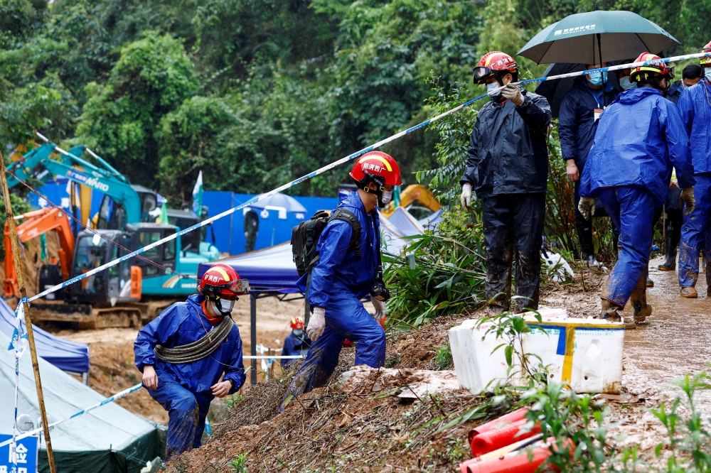 Rescue workers work at the site where a China Eastern Airlines Boeing 737-800 plane flying from Kunming to Guangzhou crashed, in Wuzhou, Guangxi Zhuang Autonomous Region, China March 24, 2022. REUTERS/Carlos Garcia Rawlins/File Photo