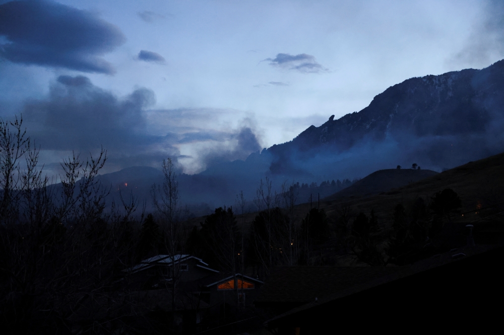 Smoke is seen during a wildfire near the National Center for Atmospheric Research (NCAR) prompted a large evacuation in Boulder, Colorado, U.S. March 26, 2022. REUTERS/Kevin Mohatt