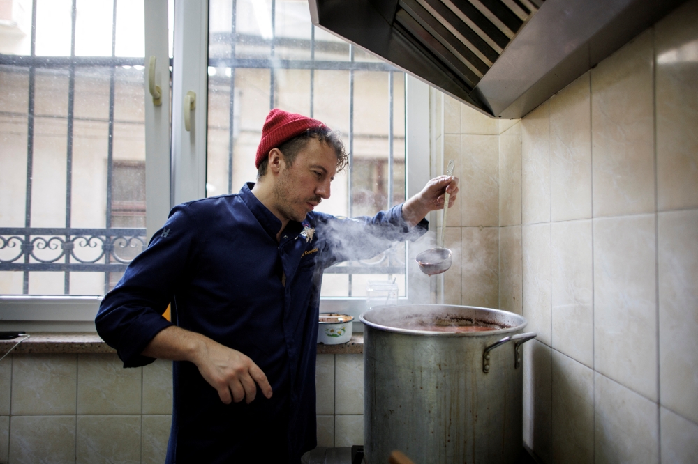 Ukrainian celebrity chef Ievgen Klopotenko checks a borscht soup in his restaurant’s kitchen, in Lviv, Ukraine, March 29, 2022. Klopotenko, who came from Kyiv to Lviv when Russia’s attack on Ukraine started, opened a restaurant where he offers free meals for refugees. REUTERS/Alkis Konstantinidis
