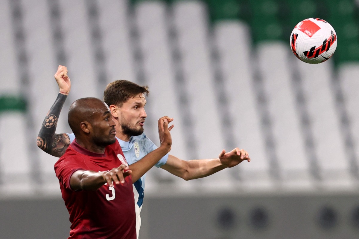 Qatar’s Abdelkarim Hassan and Slovenia’s Petar Stojanovic vie for the ball during their friendly at the Education City Stadium, yesterday.