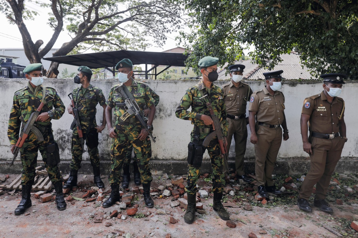 Sri Lankan Special Task Force and Police officers stand guard at the top of the road to Sri Lankan President Gotabaya Rajapaksa's residence, after police officers and demonstrators clashed at a protest against him, as many parts of the crisis-hit country faced up to 13 hours without electricity due to a shortage of foreign currency to import fuel, in Colombo, Sri Lanka April 1, 2022. REUTERS/Dinuka Liyanawatte

