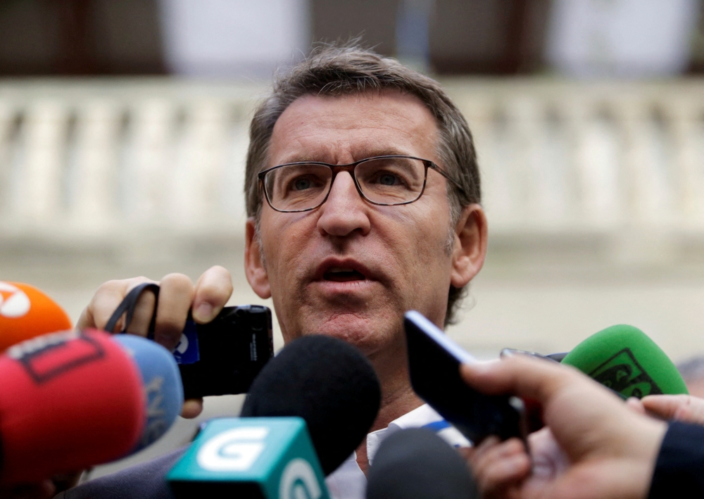 Galician President and member of the People's Party (PP) Alberto Nunez Feijoo talks to reporters outside a polling station after voting in Galician regional elections in Vigo, northern Spain, September 25, 2016. Reuters/Miguel Vidal/File Photo