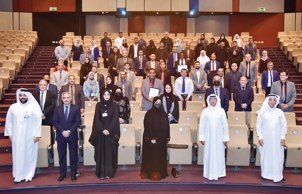 Ministry and UDST officials with training programme participants at the closing ceremony. 