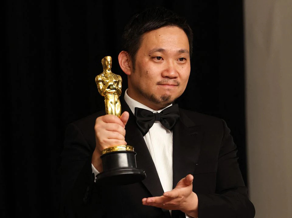 Director Ryusuke Hamaguchi poses with the Oscar for Best International Feature Film for 