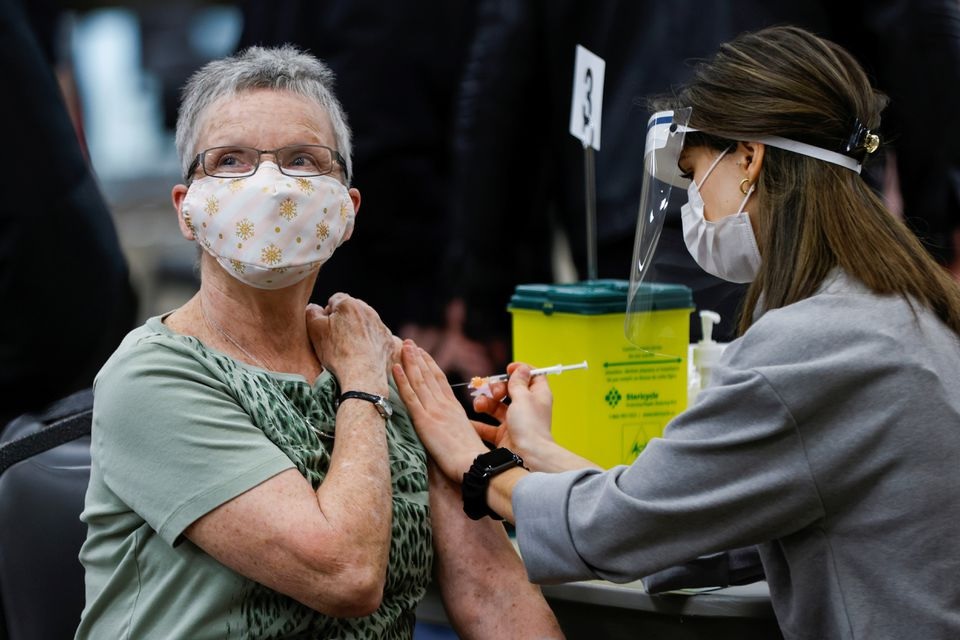 A woman receives a COVID-19 vaccine at a clinic, as efforts continue to help slow the spread of the coronavirus disease, in Ottawa, Ontario, Canada March 30, 2021. REUTERS/Blair Gable/File Photo