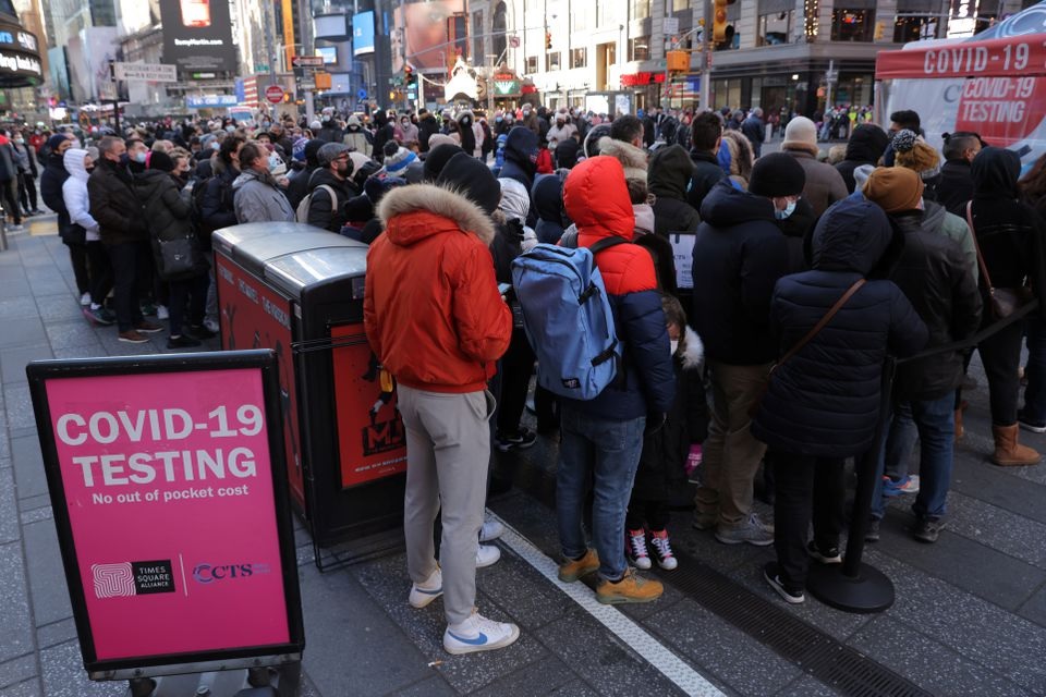 People queue for a COVID-19 test in Times Square as the Omicron coronavirus variant continues to spread in Manhattan, New York City, U.S., December 26, 2021. REUTERS/Andrew Kelly