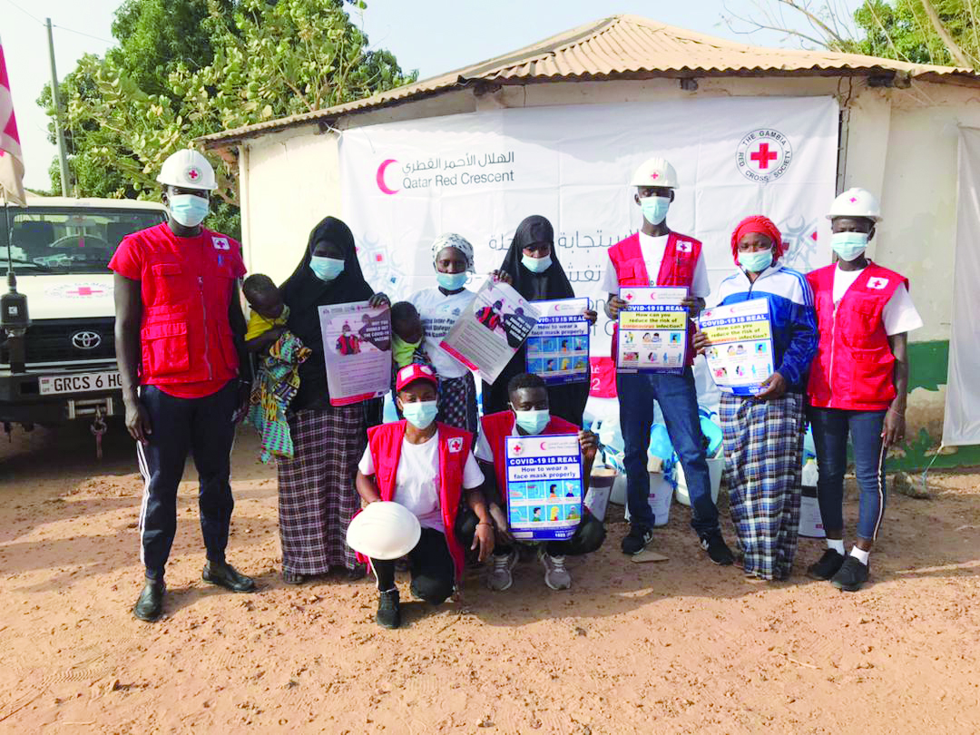QRCS volunteers distributing sanitation and hygiene kits to people in Gambia.