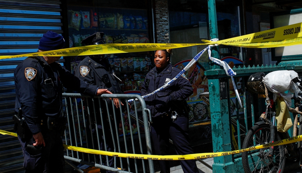 Law enforcement officers stand guard at the scene of a shooting at a subway station in the Brooklyn borough of New York City, New York, U.S., April 12, 2022. Reuters/Eduardo Munoz