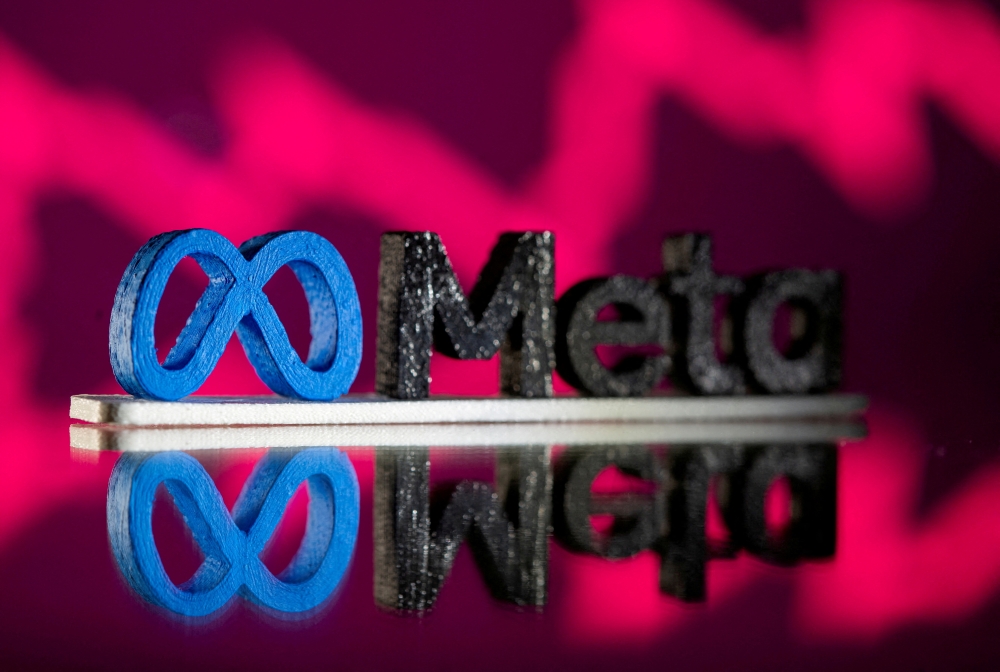 A 3D printed Facebook's new rebrand logo Meta is seen in front of displayed stock graph in this illustration taken on November 2, 2021. REUTERS/Dado Ruvic/Illustration//File Photo