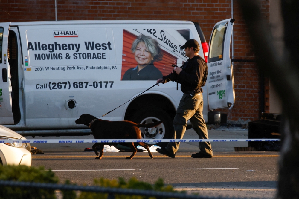 A law enforcement officer conducts an investigation of a van that police say is connected with the shooting at a subway station in the Brooklyn borough of New York City, New York, U.S., April 12, 2022. REUTERS/Eduardo Munoz