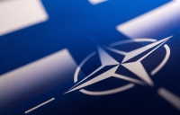 Finnish and NATO flags are seen printed on paper this illustration. Reuters/Dado Ruvic/Illustration
