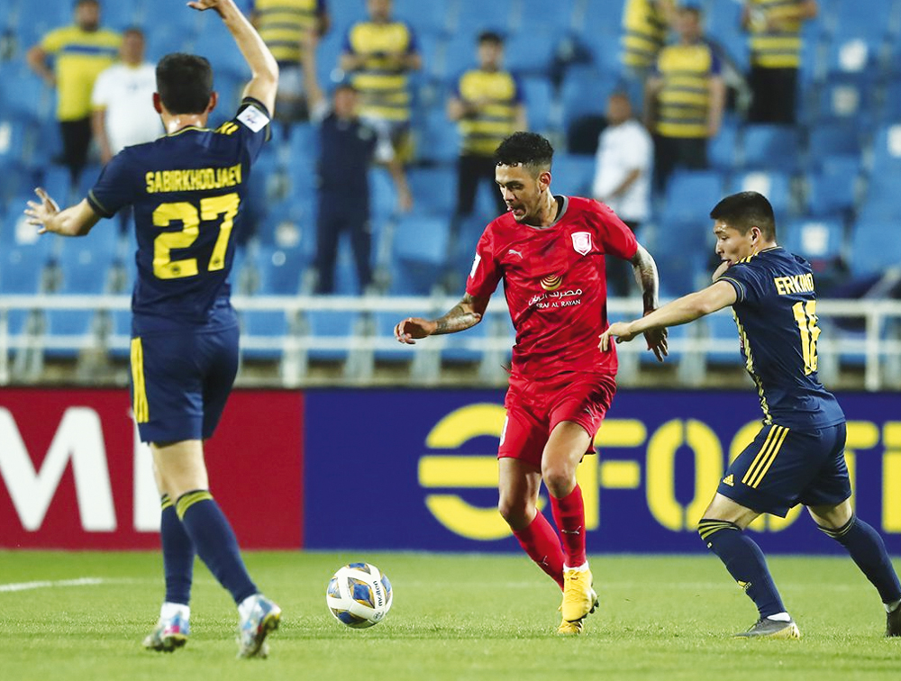 Al Duhail's Edmilson Junior (centre) in action against Pakhtakor FC's players yesterday. PIC: AFC