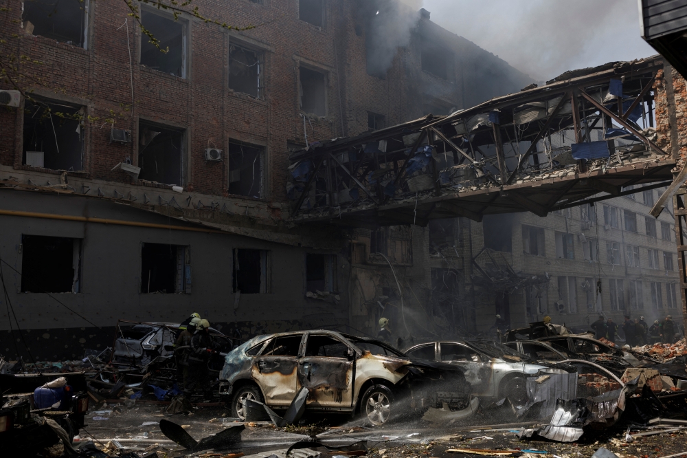 Burned cars are seen outside a destroyed building following Russian shelling, as Russia's attack on Ukraine continues, in Kharkiv, Ukraine, April 16, 2022. (REUTERS/Alkis Konstantinidis)