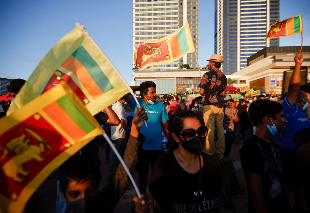 Demonstrators hold Sri Lankan national flags and shout slogans during a protest against Sri Lankan President Gotabaya Rajapaksa, in Colombo, Sri Lanka, April 16, 2022. Reuters/Navesh Chitrakar
