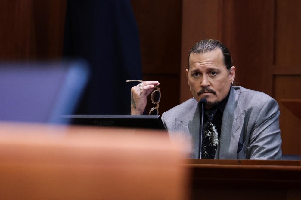 Actor Johnny Depp looks on at the end of the second day of his testimony during the defamation trial against his ex-wife Amber Heard, at the Fairfax County Circuit Courthouse in Fairfax, Virginia, U.S., April 20, 2022. REUTERS/Evelyn Hockstein/Pool