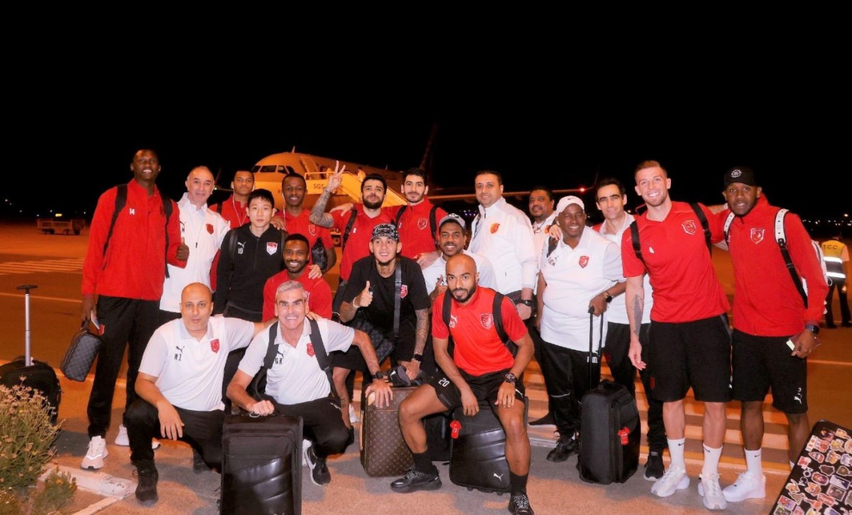 Al Duhail players and officials pose for a group photo ahead of their departure for Doha. 